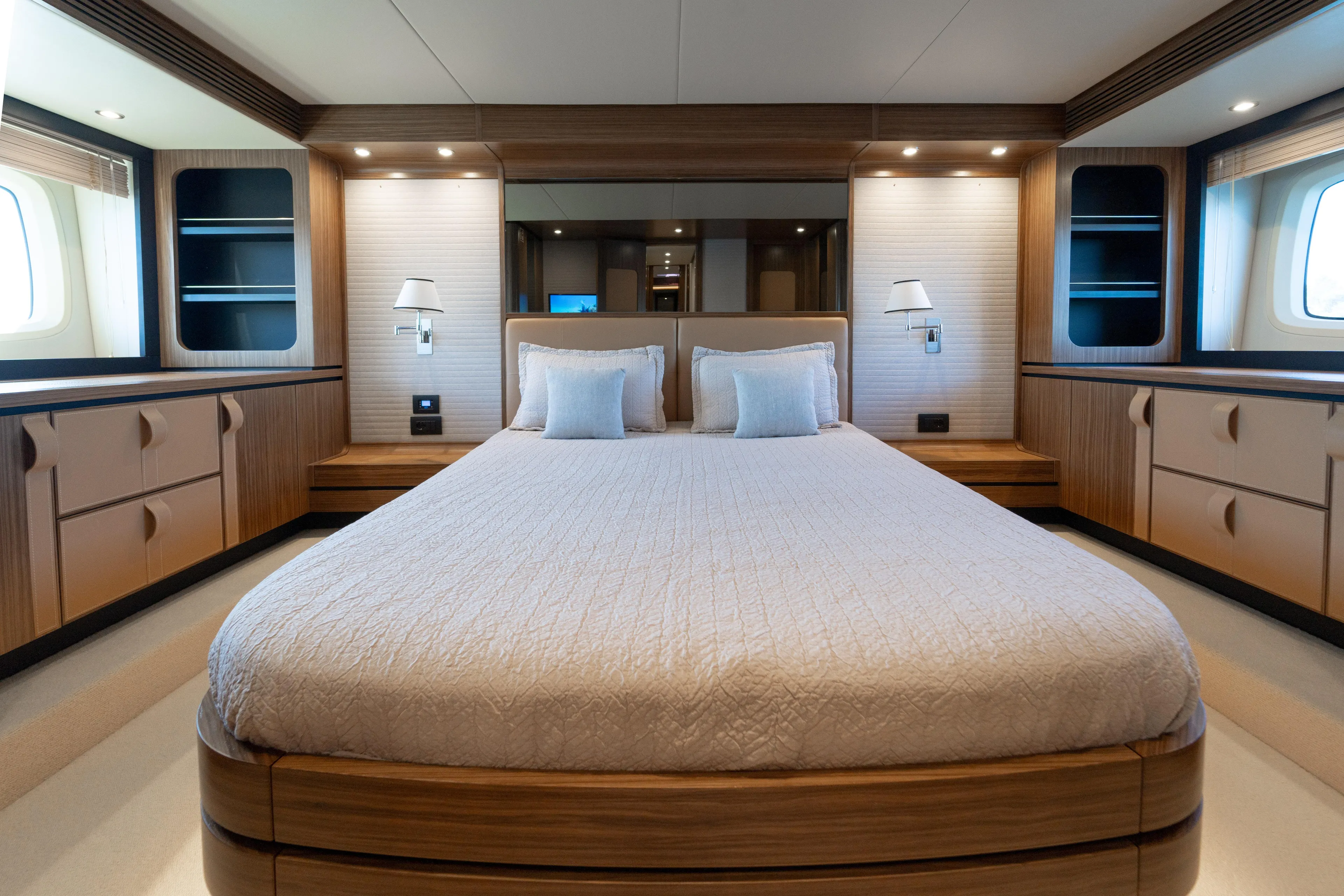 Izi Yacht Photos Pics Luxurious bedroom interior of 2017 Azimut Magellano 66 yacht with elegant wood finishes.