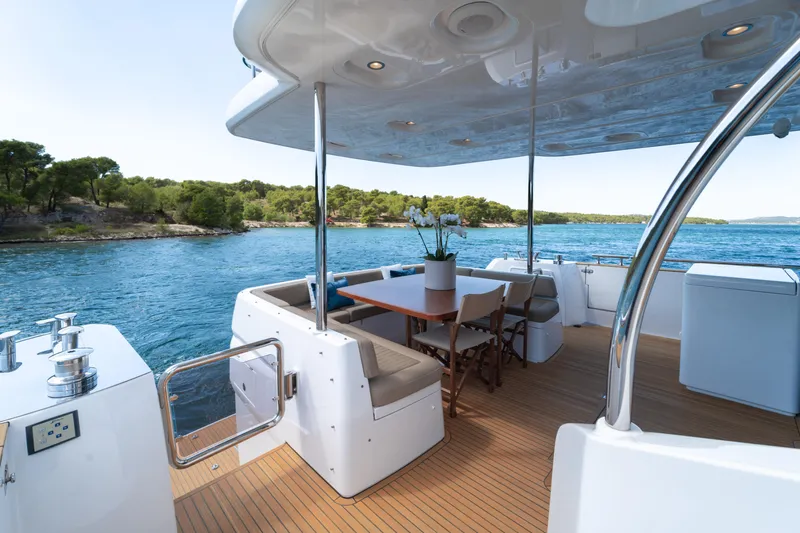 Izi Yacht Photos Pics Luxurious 2017 Azimut Magellano 66 yacht deck with seating, overlooking serene waters.