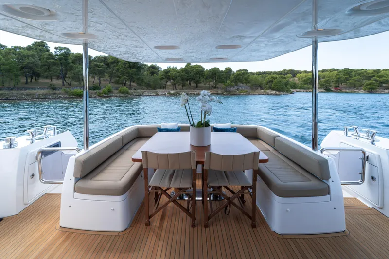 Izi Yacht Photos Pics Luxurious 2017 Azimut Magellano 66 yacht deck with elegant seating and scenic water view.