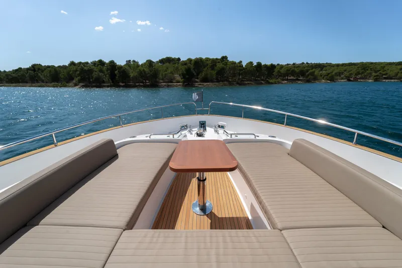 Izi Yacht Photos Pics Luxurious 2017 Azimut Magellano 66 yacht deck with seating, table, and scenic ocean view.