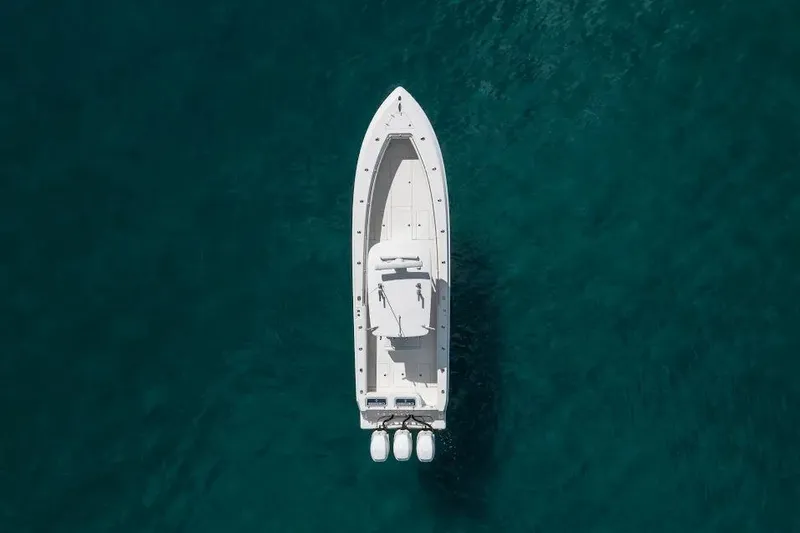  Yacht Photos Pics Aerial view of 2013 Contender 35 ST boat on clear blue water.