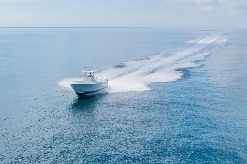  Yacht Photos Pics 2013 Contender 35 ST boat cruising on open blue ocean waters.