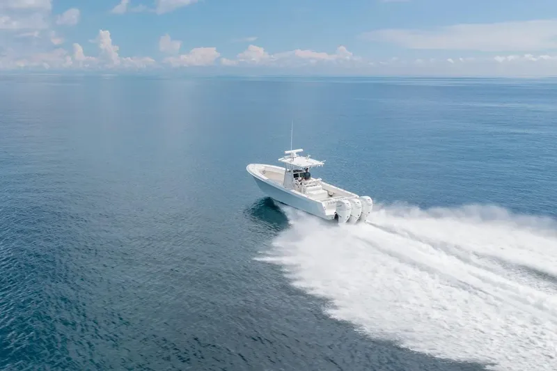 Yacht Photos Pics 2013 Contender 35 ST boat speeding on open ocean under clear blue sky.