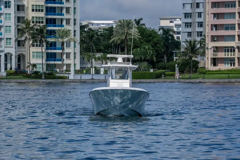  Yacht Photos Pics 2013 Contender 35 ST boat on water with buildings in the background.