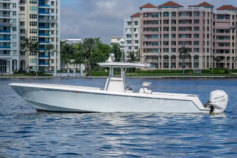 Yacht Photos Pics 2013 Contender 35 ST boat on water with cityscape background.