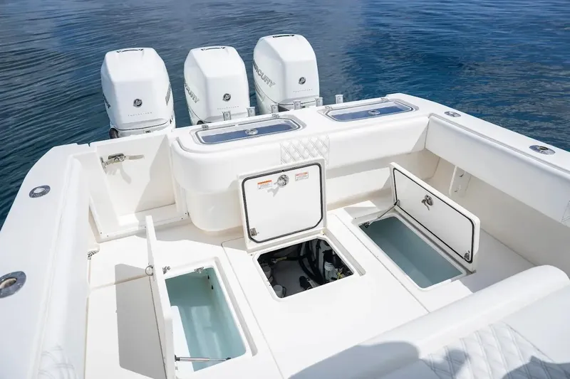  Yacht Photos Pics 2013 Contender 35 ST boat with open storage compartments and triple Mercury engines.