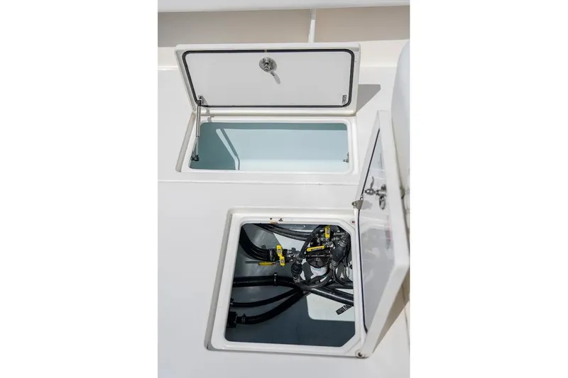  Yacht Photos Pics Open compartments on a 2013 Contender 35 ST boat, showing internal wiring and storage.