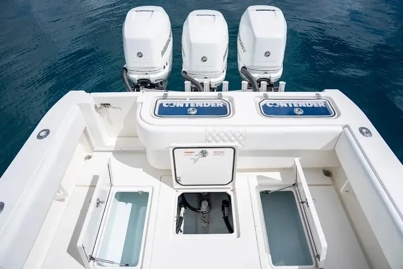  Yacht Photos Pics 2013 Contender 35 ST boat with triple outboard engines and open storage compartments.