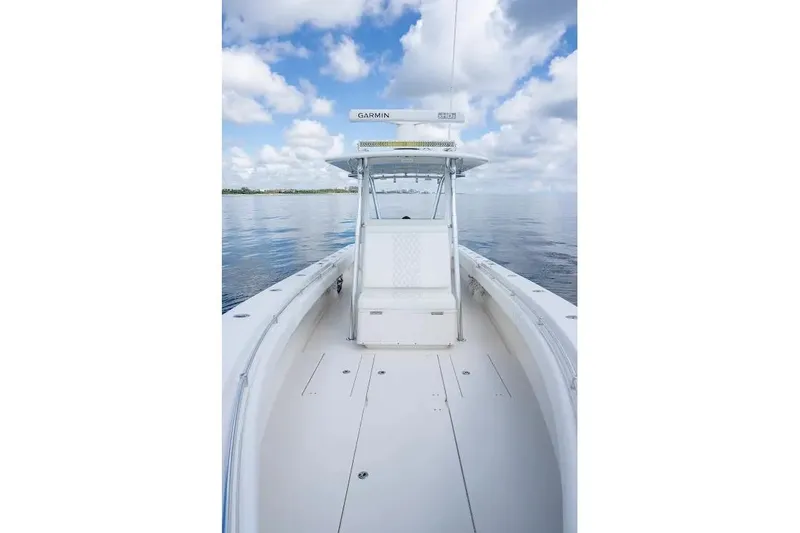  Yacht Photos Pics 2013 Contender 35 ST boat on calm water under a cloudy sky.