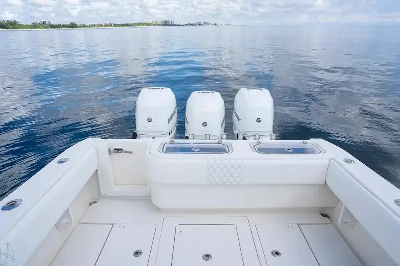  Yacht Photos Pics 2013 Contender 35 ST boat with triple engines on calm water.