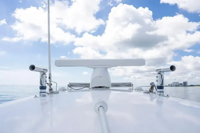  Yacht Photos Pics 2013 Contender 35 ST boat radar system under a bright blue sky with clouds.