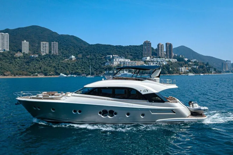 Wasana Yacht Photos Pics Luxurious 2015 Monte Carlo Yachts MCY 70 cruising near scenic coastline.