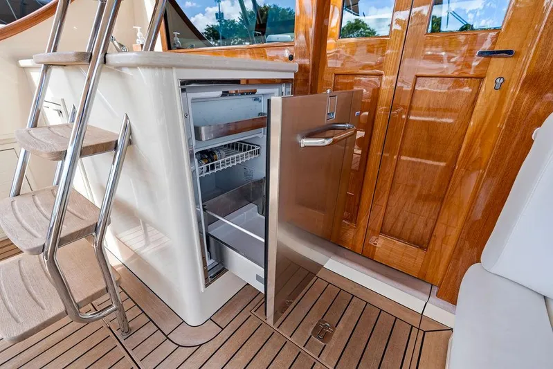Tutto Bene Yacht Photos Pics 2018 Palm Beach Motor Yachts PB55 Flybridge with open fridge, wooden deck, and stairs.
