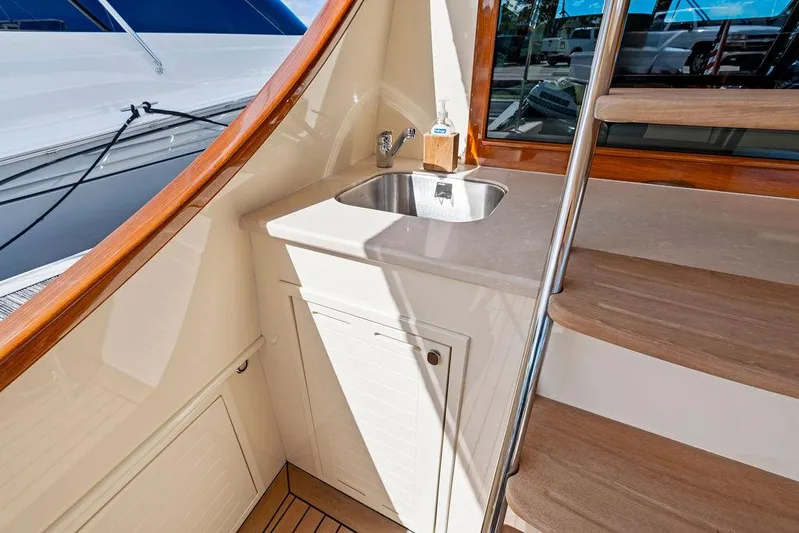 Tutto Bene Yacht Photos Pics 2018 Palm Beach Motor Yachts PB55 Flybridge with sink and wooden stairs detail.