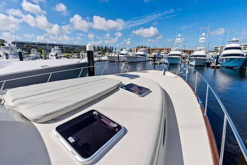 Tutto Bene Yacht Photos Pics 2018 Palm Beach Motor Yachts PB55 Flybridge docked, showcasing sleek design and marina view.