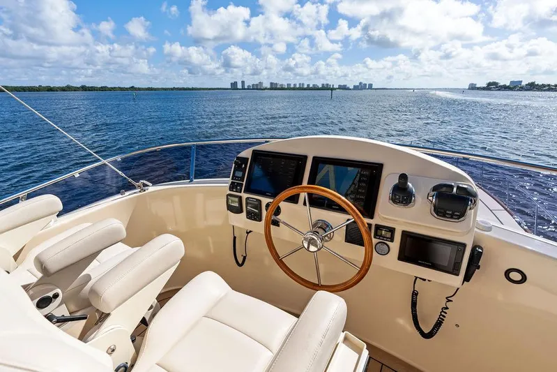 Tutto Bene Yacht Photos Pics Flybridge helm of 2018 Palm Beach Motor Yachts PB55, overlooking serene ocean view.