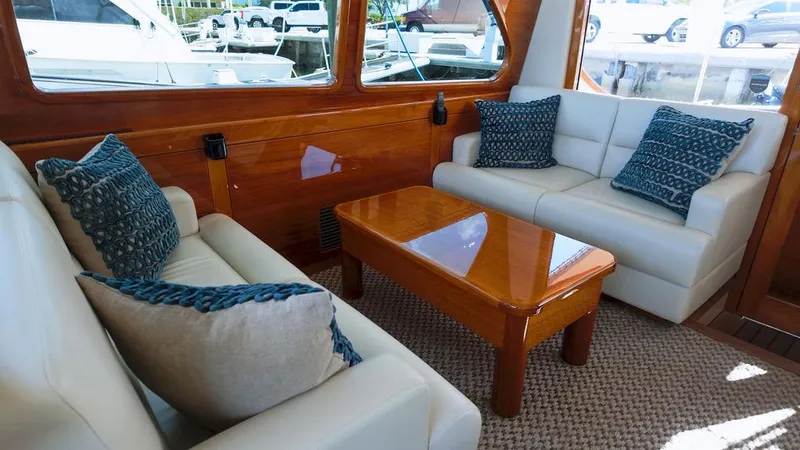 Tutto Bene Yacht Photos Pics Luxurious interior of 2018 Palm Beach Motor Yachts PB55 Flybridge with elegant seating and wooden accents.