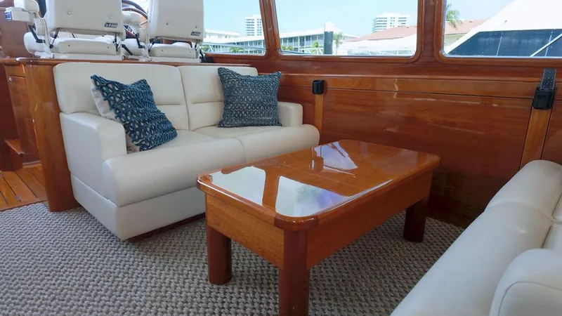 Tutto Bene Yacht Photos Pics Luxurious interior of 2018 Palm Beach Motor Yachts PB55 Flybridge with elegant seating and wooden table.