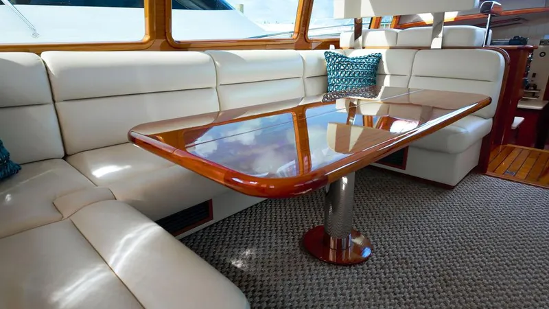 Tutto Bene Yacht Photos Pics Luxurious interior of 2018 Palm Beach Motor Yachts PB55 Flybridge with elegant seating and wooden table.