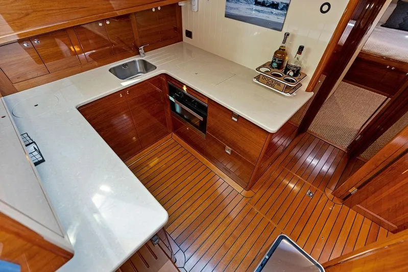 Tutto Bene Yacht Photos Pics Luxurious 2018 Palm Beach PB55 Flybridge yacht kitchen with sleek wood finish and modern appliances.