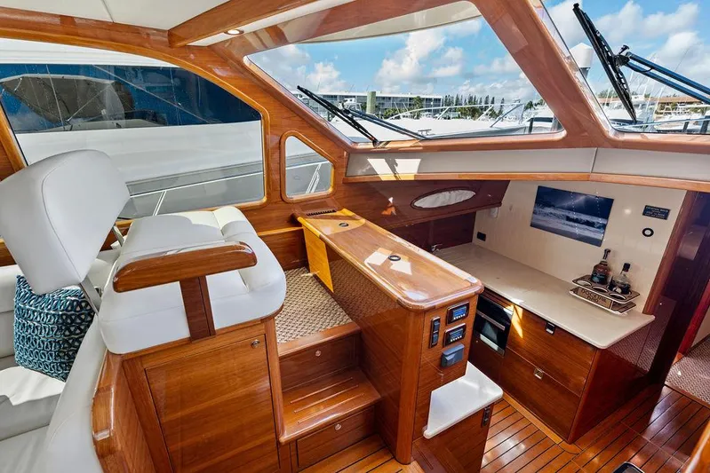 Tutto Bene Yacht Photos Pics Luxurious interior of 2018 Palm Beach Motor Yachts PB55 Flybridge with elegant wood finish.