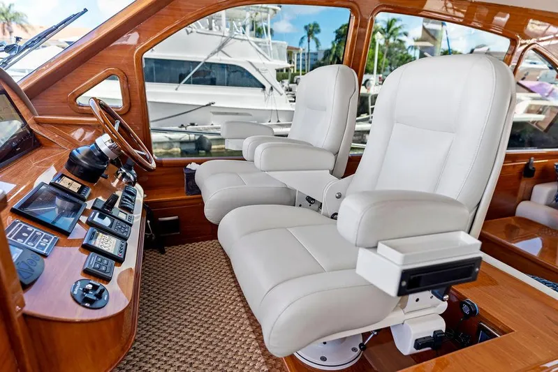 Tutto Bene Yacht Photos Pics Luxurious 2018 Palm Beach Motor Yachts PB55 Flybridge helm with plush white captain chairs.