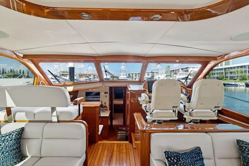 Tutto Bene Yacht Photos Pics 2018 Palm Beach Motor Yachts PB55 Flybridge interior with luxurious seating and helm, docked at marina.