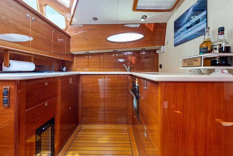 Tutto Bene Yacht Photos Pics Luxurious wooden interior of 2018 Palm Beach Motor Yachts PB55 Flybridge kitchen area.