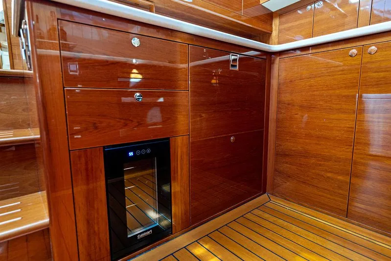 Tutto Bene Yacht Photos Pics Luxurious wooden interior of 2018 Palm Beach Motor Yachts PB55 Flybridge with built-in wine cooler.