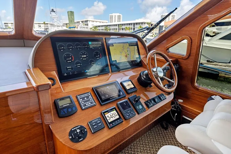 Tutto Bene Yacht Photos Pics Helm of 2018 Palm Beach Motor Yachts PB55 Flybridge with navigation screens and controls.
