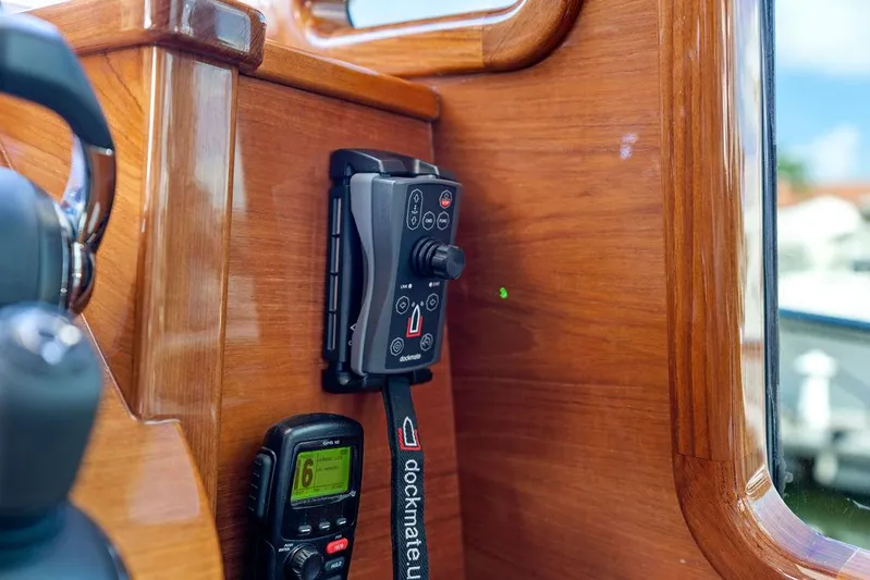 Tutto Bene Yacht Photos Pics Control panel and radio on 2018 Palm Beach Motor Yachts PB55 Flybridge, wooden interior detail.