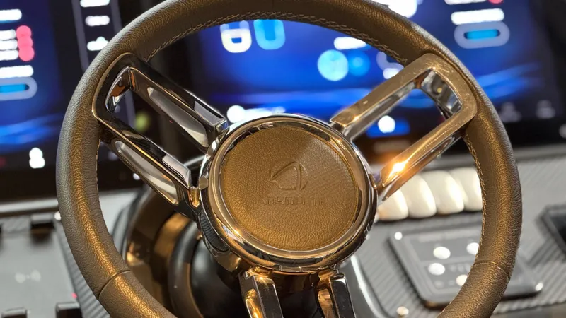  Yacht Photos Pics Steering wheel of 2022 Absolute 60 Fly yacht with digital dashboard in background.