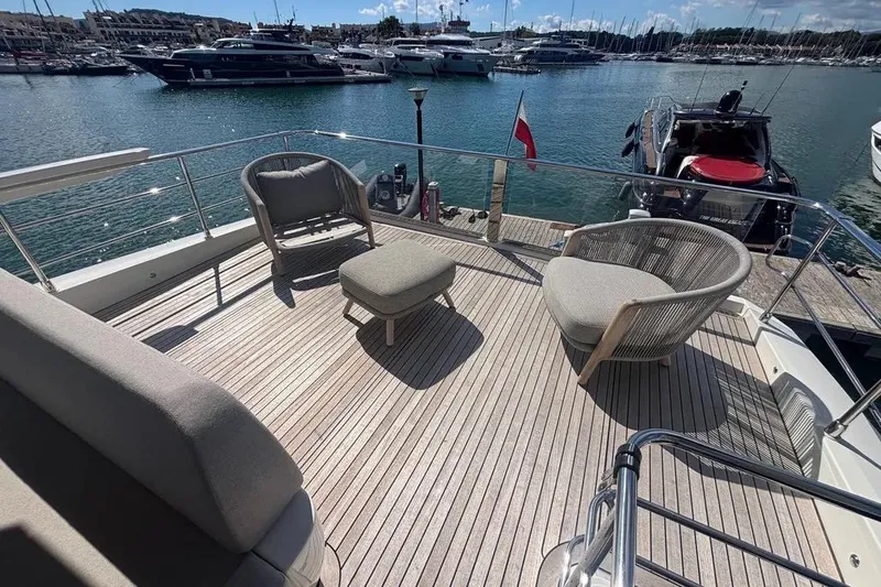  Yacht Photos Pics Luxurious deck of 2023 Absolute 60 Fly yacht with elegant seating and scenic marina view.