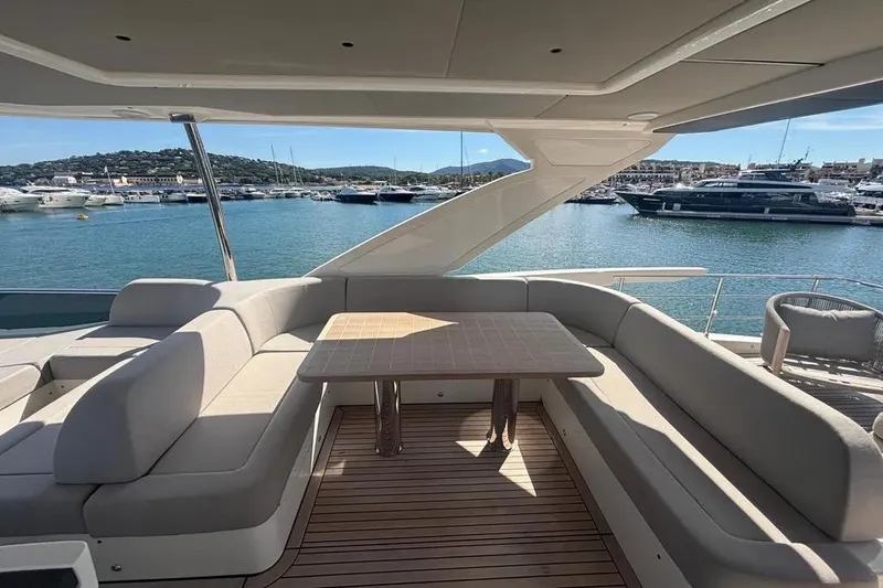  Yacht Photos Pics Luxurious 2023 Absolute 60 Fly yacht with elegant seating and scenic marina view.