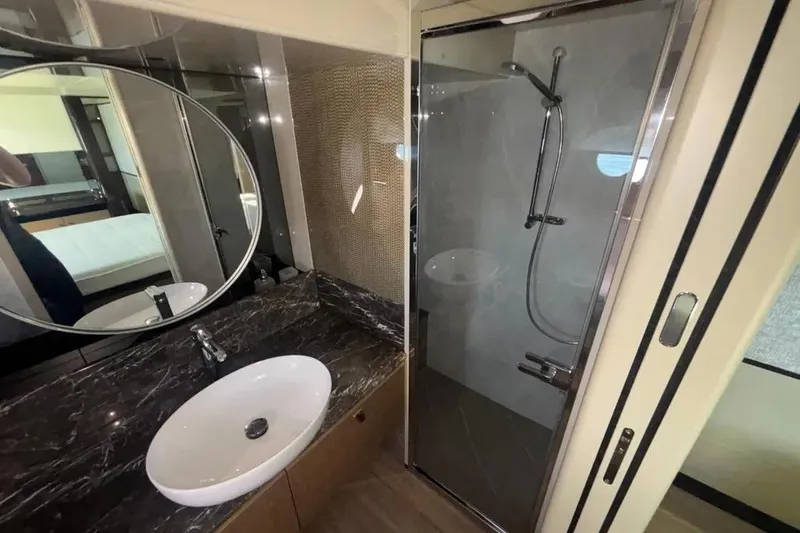  Yacht Photos Pics Luxurious bathroom in 2023 Absolute 60 Fly yacht with modern shower and elegant sink.