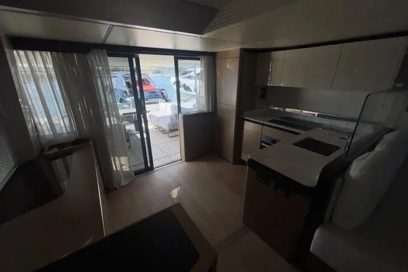  Yacht Photos Pics Luxurious interior of 2023 Absolute 60 Fly yacht with modern kitchen and outdoor view.