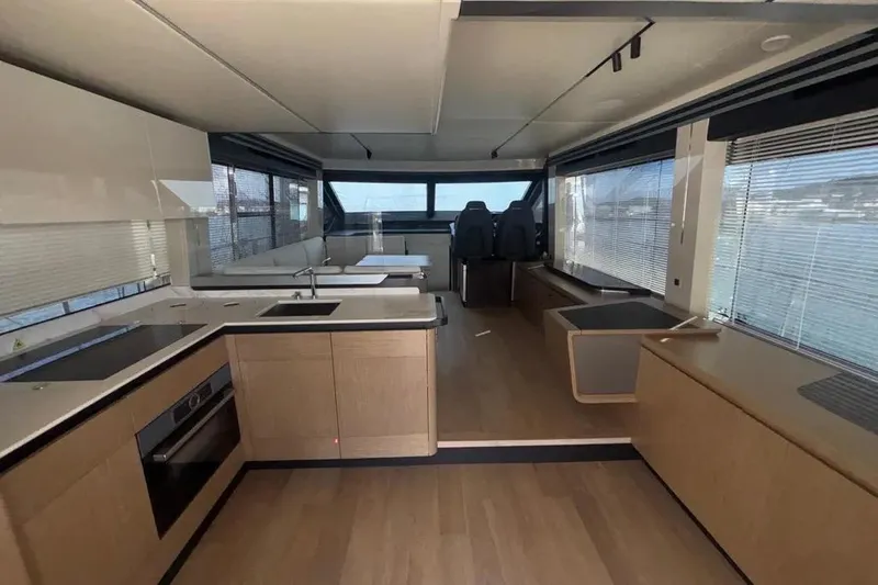  Yacht Photos Pics Luxurious interior of 2023 Absolute 60 Fly yacht with modern kitchen and seating area.