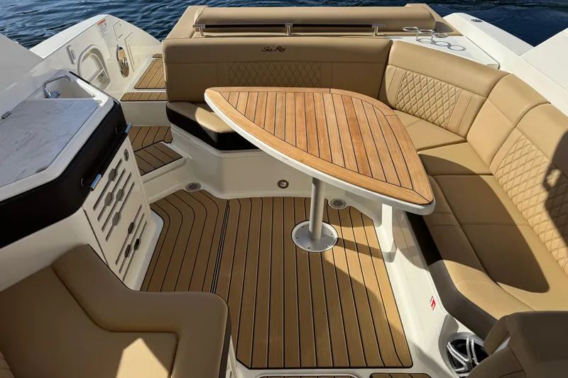  Yacht Photos Pics Luxurious 2026 Sea Ray SLX 310 boat interior with elegant seating and wooden table.