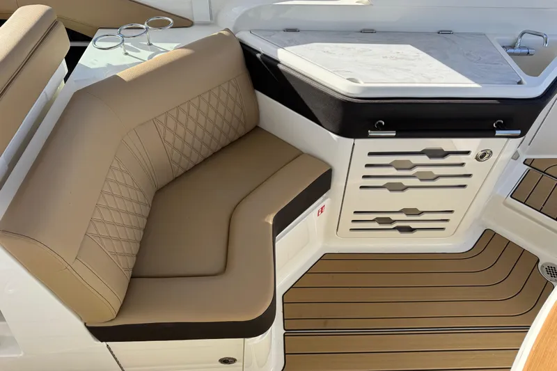  Yacht Photos Pics Luxurious seating and kitchenette on 2026 Sea Ray SLX 310 boat interior.