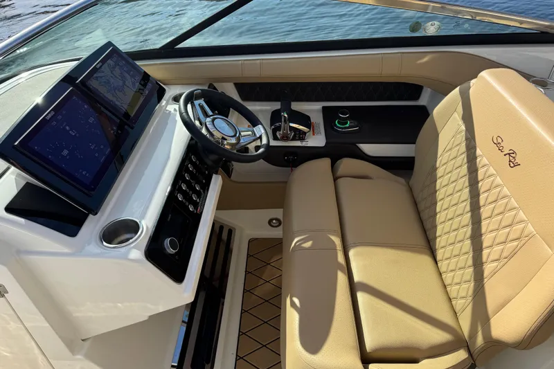  Yacht Photos Pics Interior of 2026 Sea Ray SLX 310 boat with modern dashboard and leather seating.