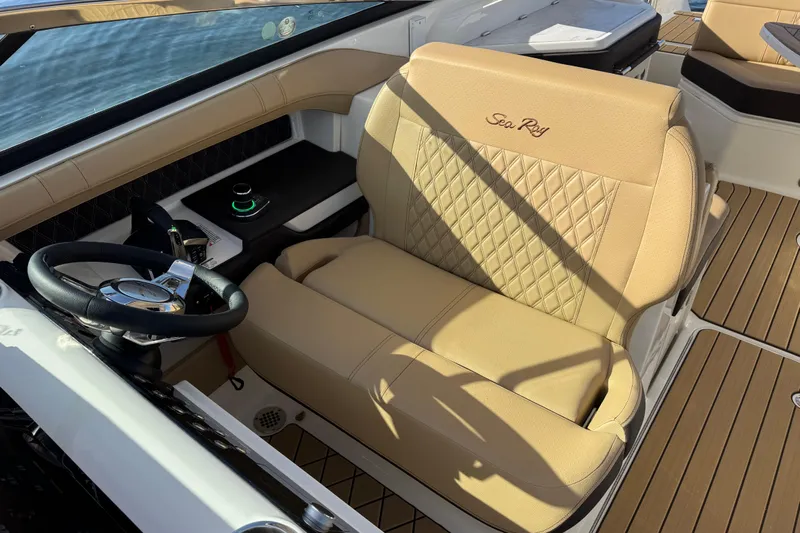  Yacht Photos Pics 2026 Sea Ray SLX 310 helm with luxurious tan seating and modern controls.