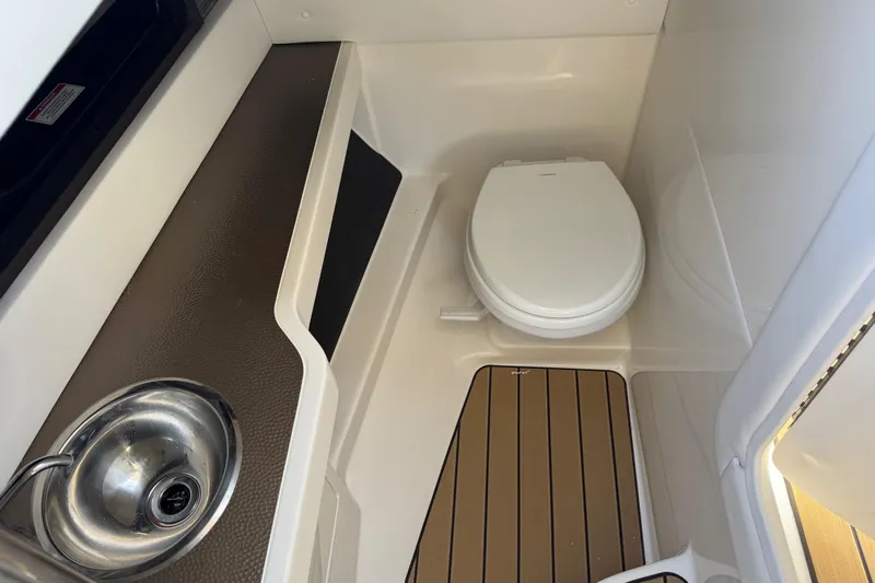  Yacht Photos Pics 2026 Sea Ray SLX 310 boat bathroom with sink and toilet.