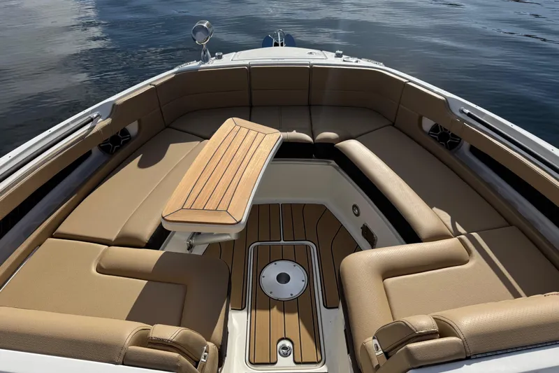  Yacht Photos Pics Luxurious interior of 2026 Sea Ray SLX 310 boat with tan seating and wooden table.