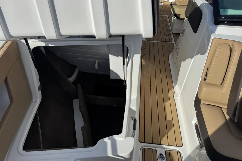  Yacht Photos Pics 2026 Sea Ray SLX 310 boat interior with open storage compartment and tan seating.