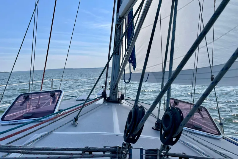 Quest Yacht Photos Pics Sailing on a 2004 Catalina 350 yacht, open sea view, clear blue sky.