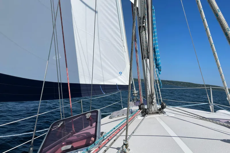 Quest Yacht Photos Pics Sailing on a 2004 Catalina 350 yacht with white sails and blue sky.