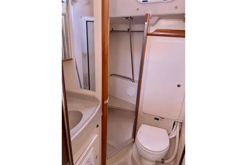 Quest Yacht Photos Pics Bathroom interior of a 2004 Catalina 350 yacht, featuring a compact toilet and sink.