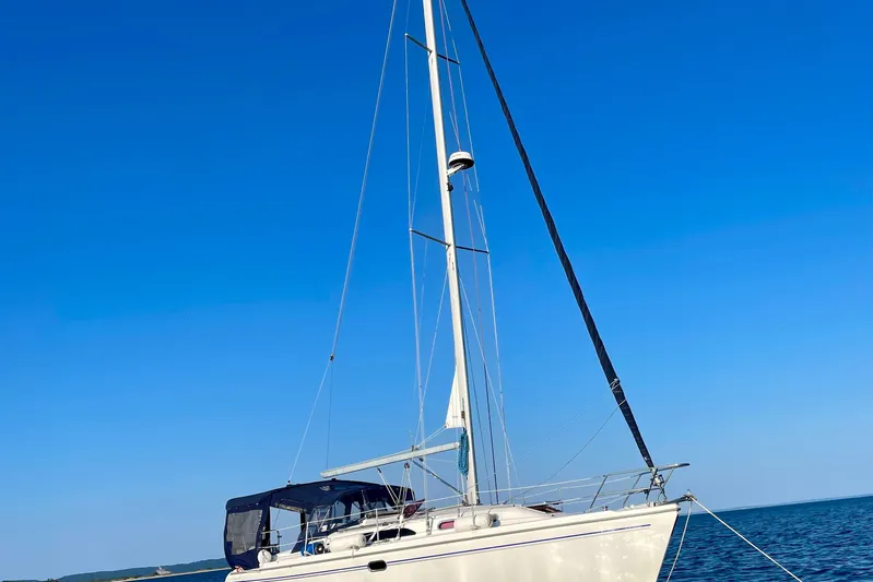 Quest Yacht Photos Pics Sailboat Catalina 350, 2004 model, anchored on calm blue sea under clear sky.