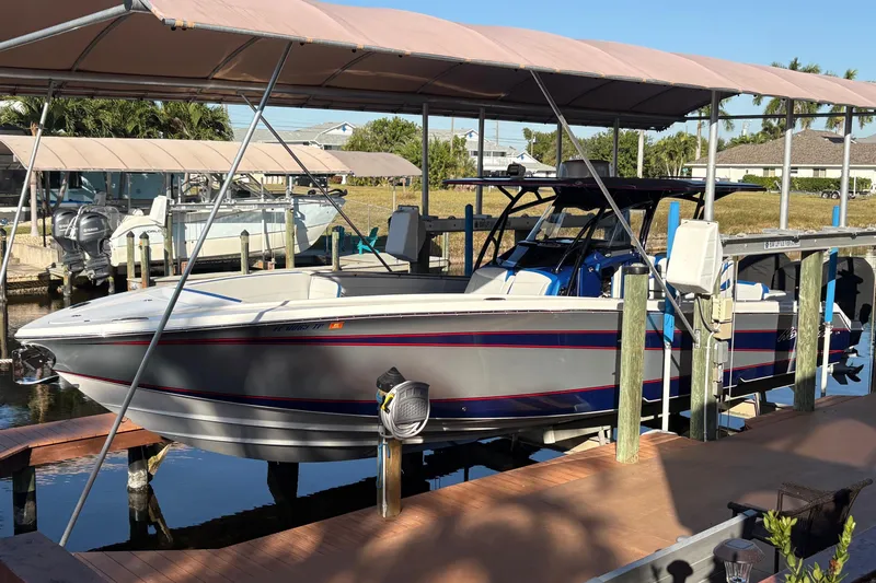  Yacht Photos Pics 2023 Nor-Tech 390 Sport Center Console boat docked under canopy.