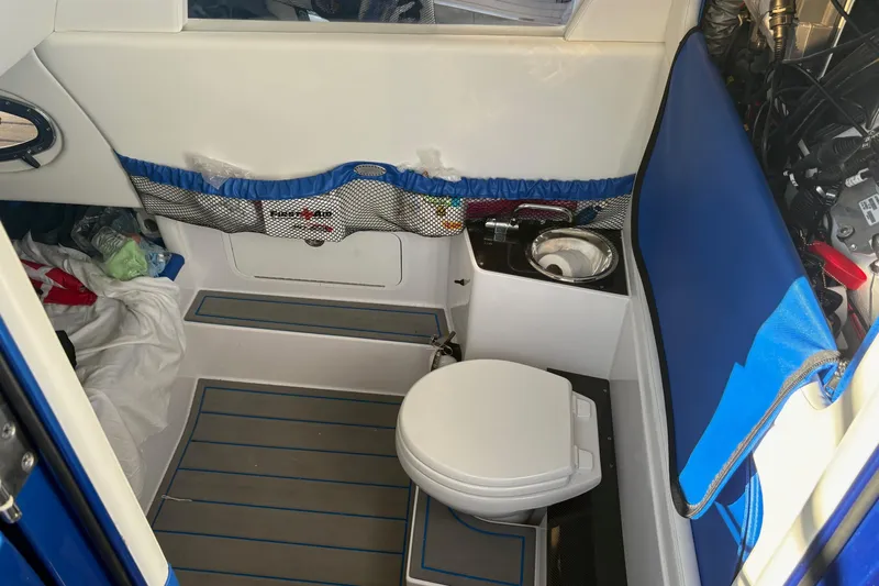  Yacht Photos Pics 2023 Nor-Tech 390 Sport Center Console interior with compact marine toilet and sink.
